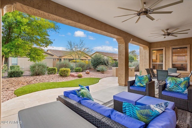 view of patio with an outdoor hangout area, outdoor dining area, a fenced backyard, and a ceiling fan