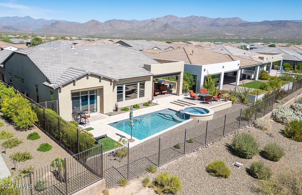 17775 E Veit Springs Dr, Rio Verde, AZ 85263 - view of pool with a fenced backyard, a pool with connected hot tub, a mountain view, and a patio