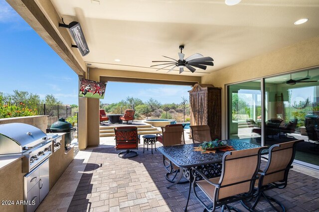 view of patio featuring exterior kitchen, ceiling fan, and grilling area