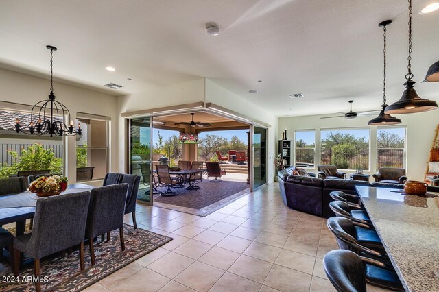 kitchen with built in appliances, pendant lighting, dark brown cabinetry, a center island with sink, and sink