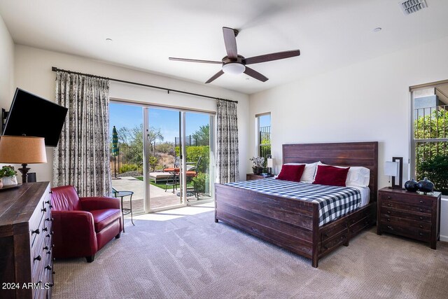 carpeted bedroom with ceiling fan and access to exterior