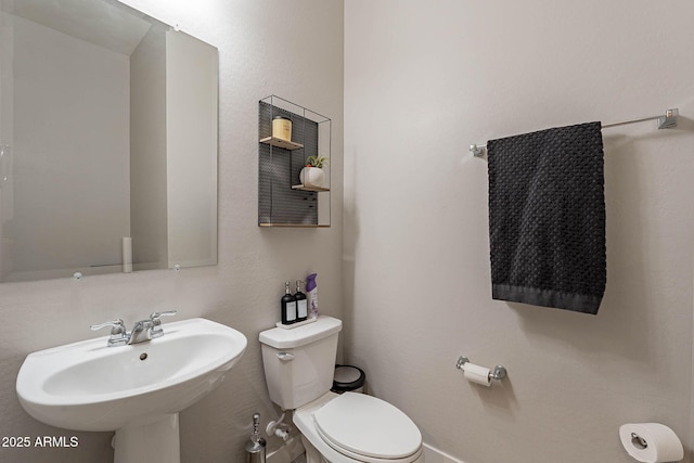 bathroom featuring toilet and sink