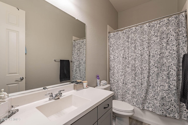 full bathroom featuring toilet, vanity, and shower / tub combo with curtain