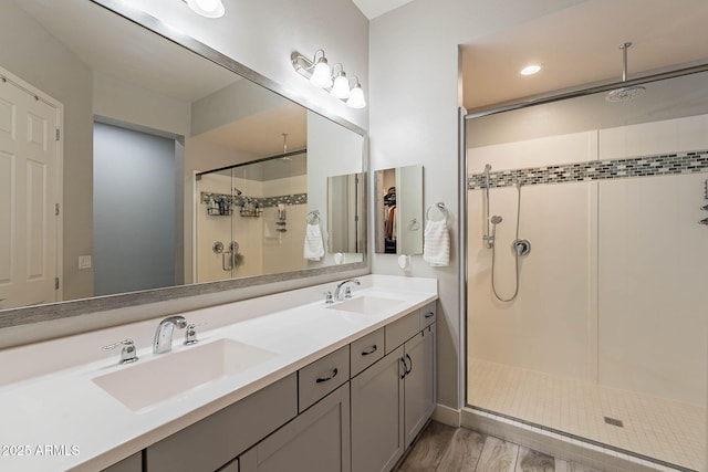 bathroom featuring vanity, a shower with door, and hardwood / wood-style floors