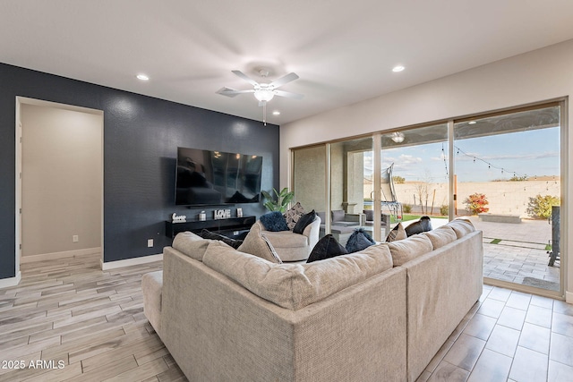 living room featuring ceiling fan and light hardwood / wood-style flooring