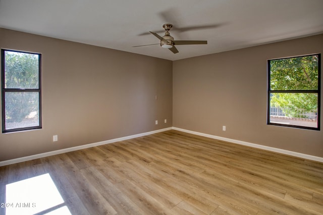 empty room with light hardwood / wood-style flooring and ceiling fan