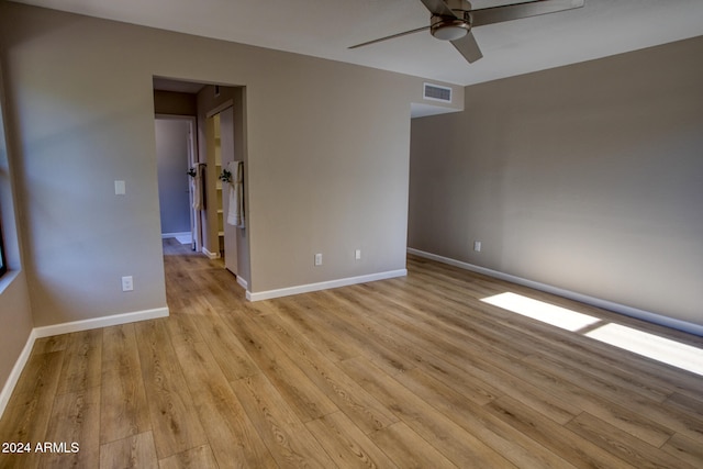 unfurnished room with light wood-type flooring and ceiling fan