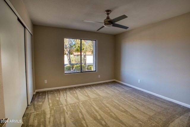 unfurnished bedroom featuring a closet, light carpet, and ceiling fan