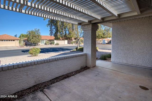 view of patio / terrace featuring a garage and a pergola