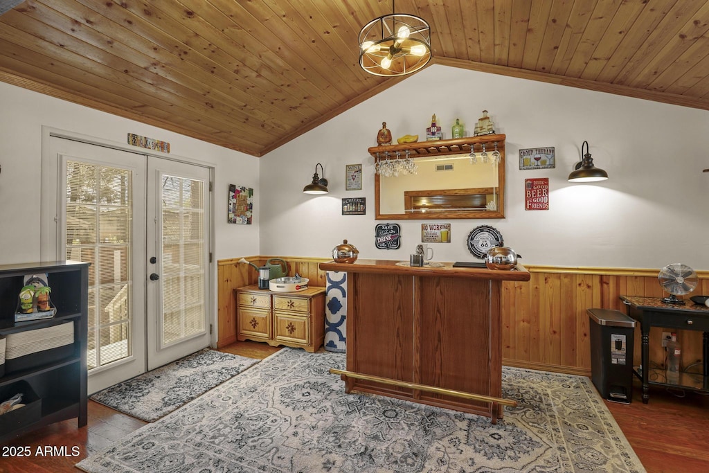 home office featuring hardwood / wood-style floors, wooden ceiling, french doors, wooden walls, and lofted ceiling