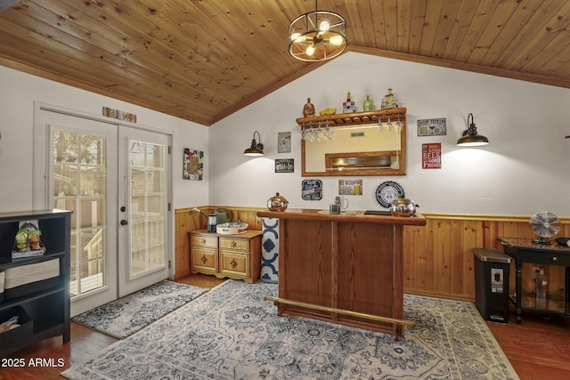 home office featuring hardwood / wood-style floors, wooden ceiling, french doors, wooden walls, and lofted ceiling