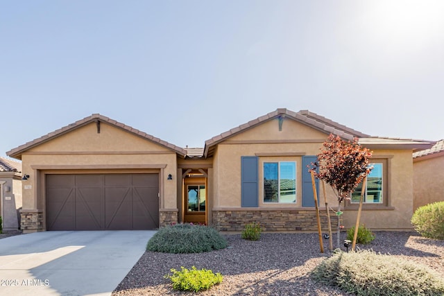 ranch-style home featuring a garage, driveway, stucco siding, and stone siding