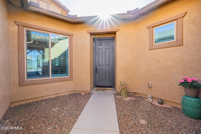 property entrance with stucco siding