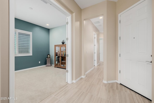 corridor with recessed lighting and baseboards