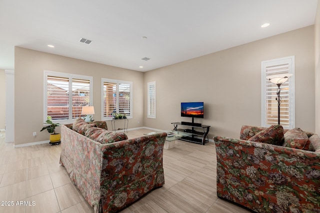 living area with recessed lighting, light tile patterned floors, visible vents, and baseboards