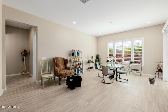 living area featuring light tile patterned floors, baseboards, and recessed lighting