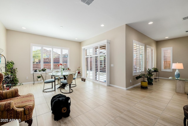 living room with light tile patterned floors, visible vents, and recessed lighting