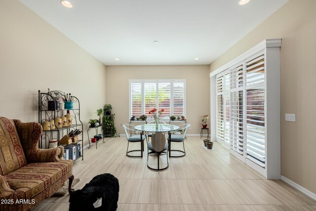 dining room featuring baseboards and recessed lighting