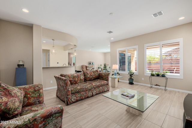 tiled living area featuring visible vents, baseboards, and recessed lighting
