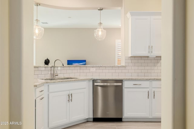 kitchen with a sink, white cabinetry, light stone countertops, backsplash, and stainless steel dishwasher