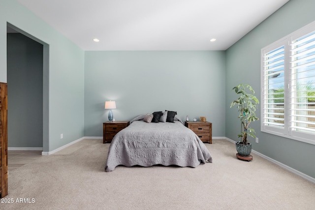 bedroom featuring carpet flooring, baseboards, multiple windows, and recessed lighting