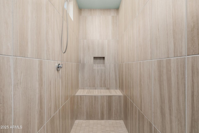 bathroom with a tile shower