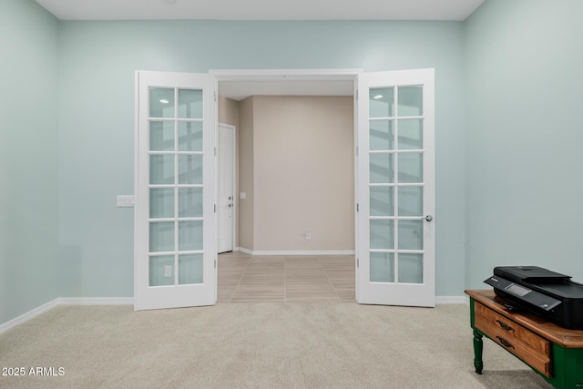 interior space featuring carpet flooring, french doors, and baseboards