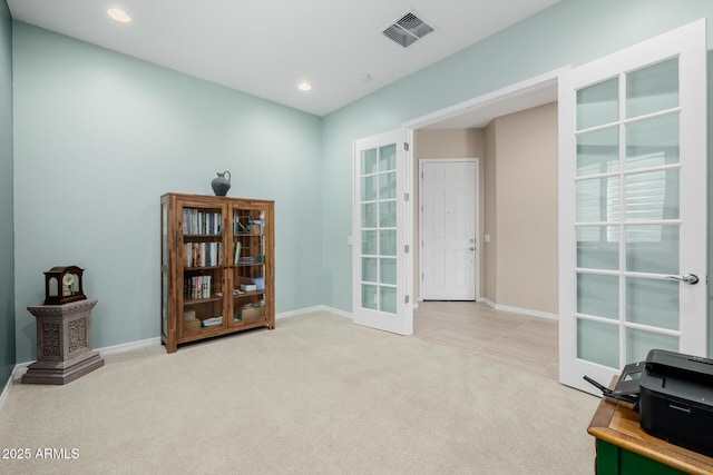 interior space with french doors, baseboards, carpet, and visible vents
