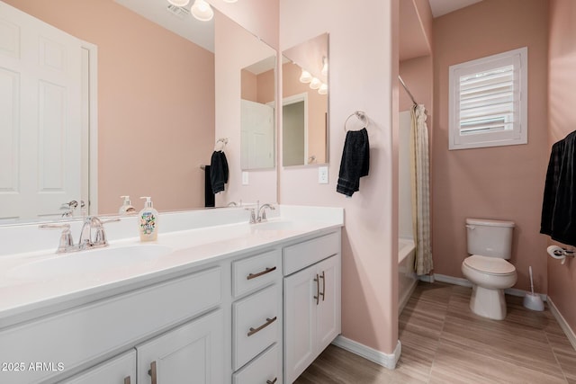 bathroom featuring visible vents, baseboards, and a sink