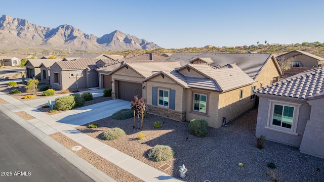 view of front of home with a residential view, driveway, stucco siding, and a tiled roof