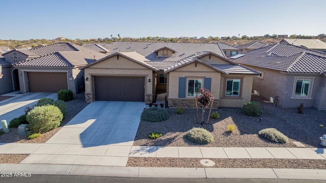 view of front of property with a tiled roof, stucco siding, an attached garage, driveway, and a residential view