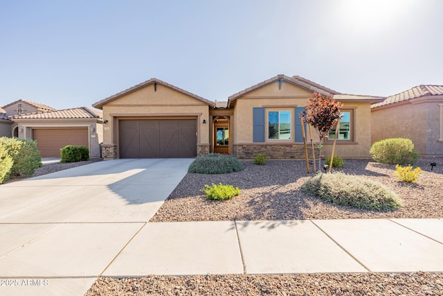 single story home with a tiled roof, stone siding, a garage, concrete driveway, and stucco siding