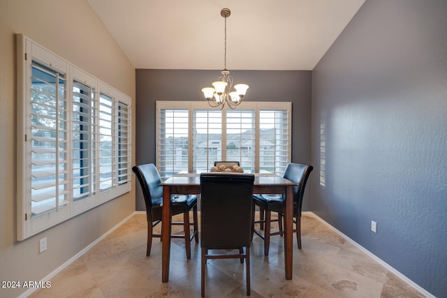 dining space with a notable chandelier and lofted ceiling