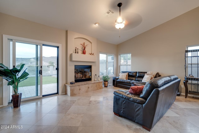 living room featuring a mountain view, a wealth of natural light, and ceiling fan