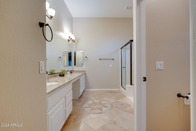 bathroom featuring vanity and a shower with door