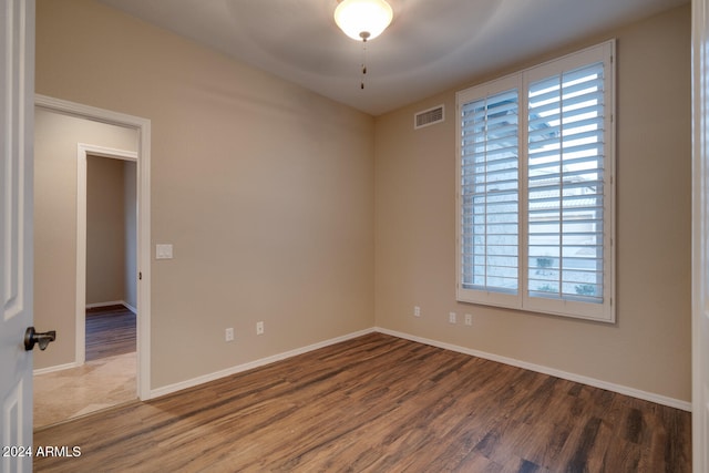 empty room with ceiling fan and hardwood / wood-style floors