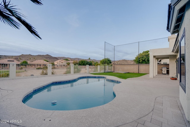 view of pool featuring a mountain view and a patio area