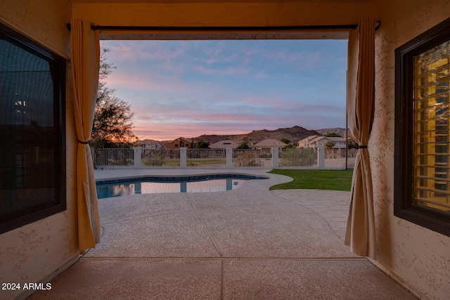 view of pool at dusk