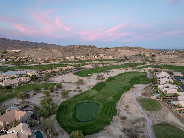 aerial view at dusk featuring a water and mountain view