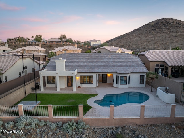 exterior space with a lawn, a mountain view, and a patio