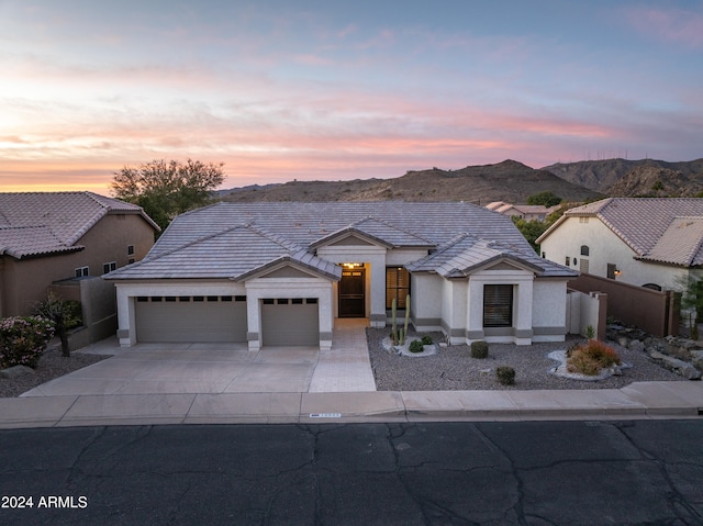 view of front of home featuring a mountain view and a garage