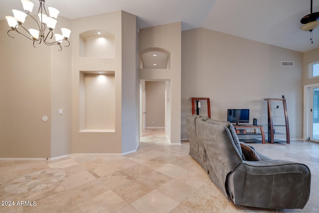 living room with high vaulted ceiling and a notable chandelier