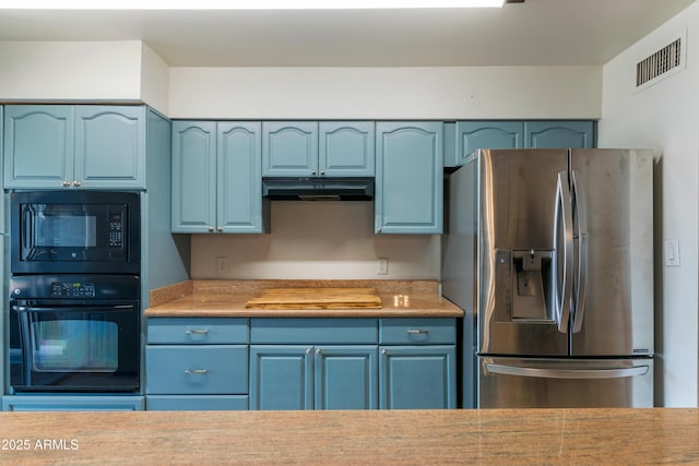 kitchen with black appliances, under cabinet range hood, and blue cabinets