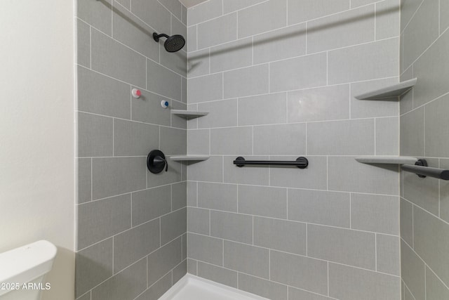 bathroom with tiled shower and toilet