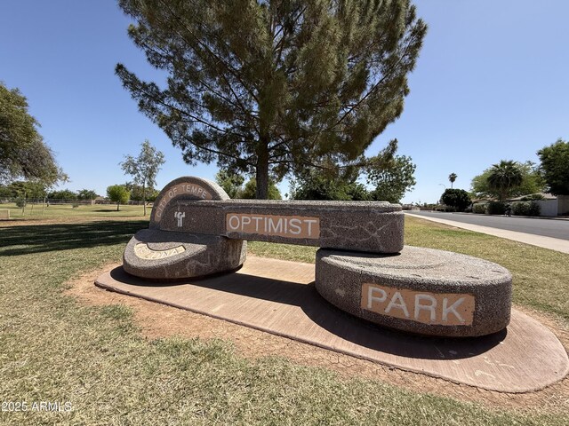 community / neighborhood sign with a lawn
