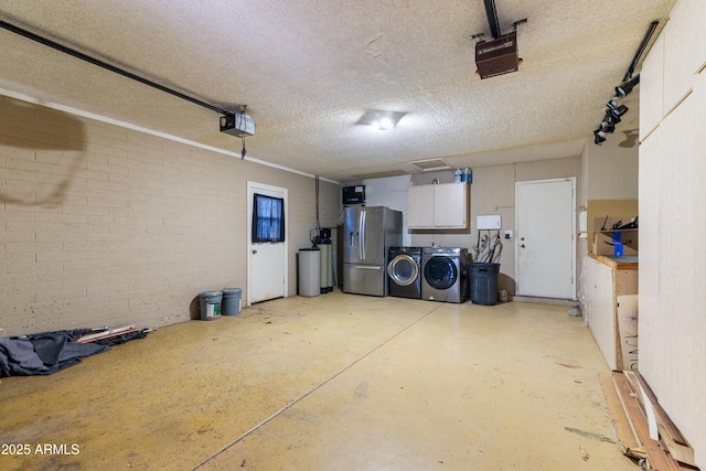 garage featuring washing machine and clothes dryer, stainless steel fridge, and a garage door opener