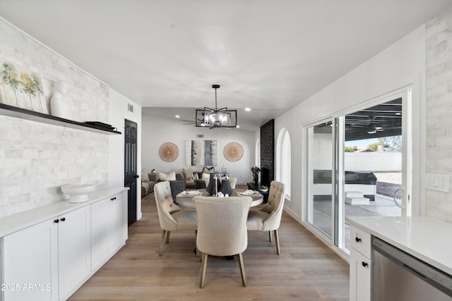 dining space featuring a chandelier and light wood finished floors