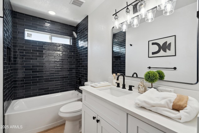 bathroom with toilet, wood finished floors, bathing tub / shower combination, vanity, and visible vents