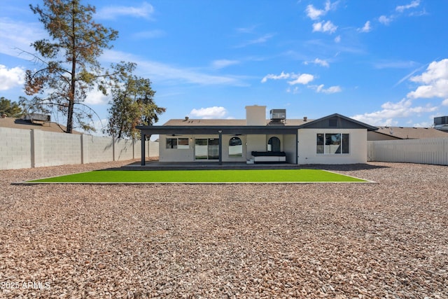 back of house featuring central air condition unit, a fenced backyard, a patio, and a yard