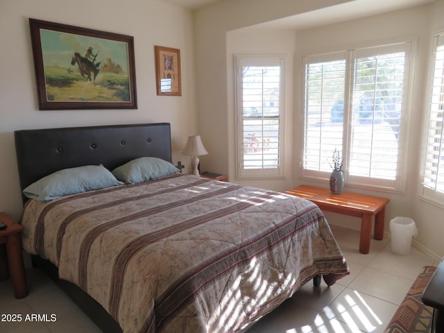 bedroom with tile patterned flooring and multiple windows